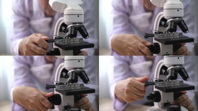 科学家用显微镜研究小细胞