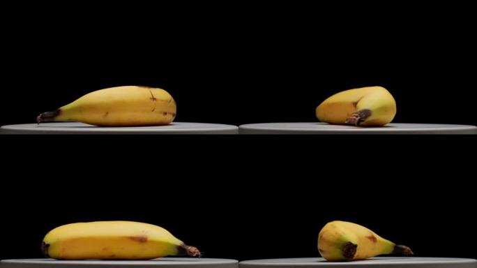平台和黑色背景上的旋转香蕉。