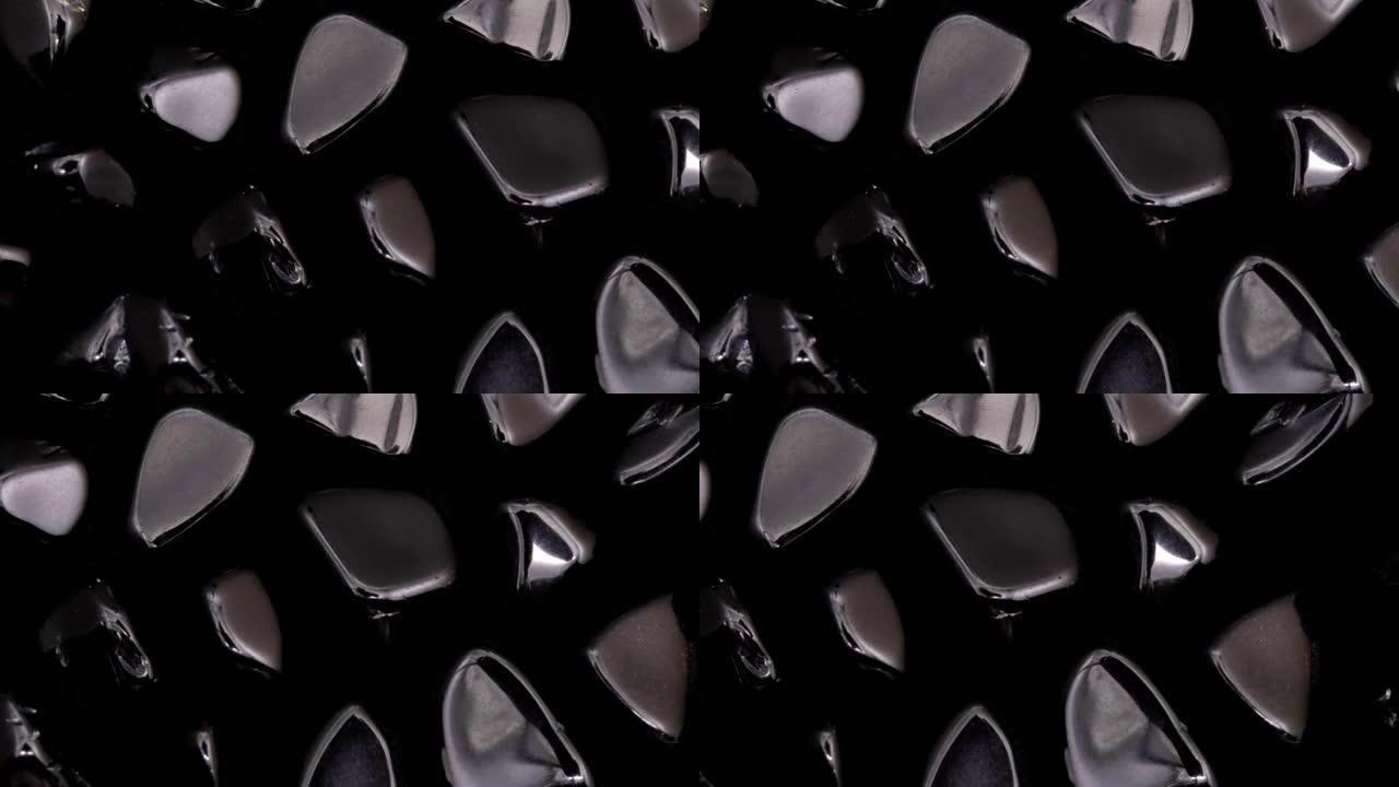 黑曜石罕见宝石纹理在黑色背景。向右移动无缝循环背景。