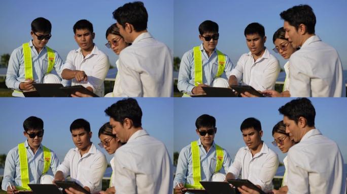 特写镜头，一组亚洲工程团队在计划操作和车站光伏太阳能电池板期间使用笔记本电脑，年轻的检查员工程师男性