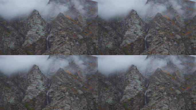 从印度喜马al尔邦的拉胡德 (Lahaul) 看到的高山云层下的短水流的4k视图。山区小瀑布上方的云