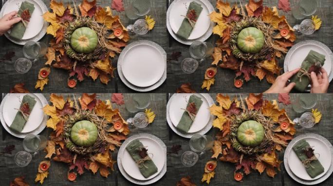 女人为感恩节大餐摆桌子。秋季表设置。顶视图。