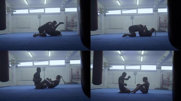 男女MMA战士地面战斗训练，宽镜头