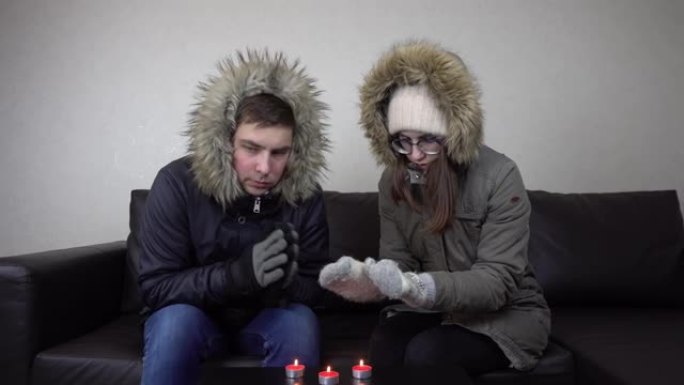 几个年轻人坐在家里穿着夹克，用蜡烛取暖。一男一女未交取暖费，家中冻僵。4k