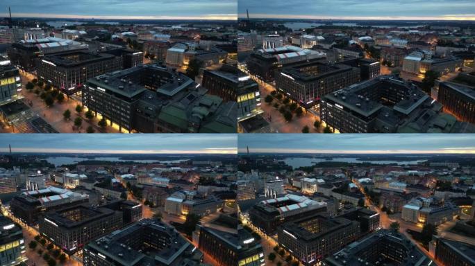 在赫尔辛基的夜间举起无人机拍摄市中心