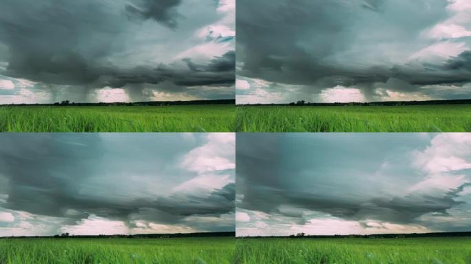 4k延时不寻常的云影响阴雨的天空，地平线上有雨云，乡村乡村田野景观上有年轻的绿色麦芽，春春夏日。云迹