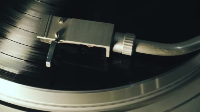 一张黑胶唱片在留声机音乐播放器中旋转，并播放旧的迪斯科舞厅。复古黑胶唱机特写镜头