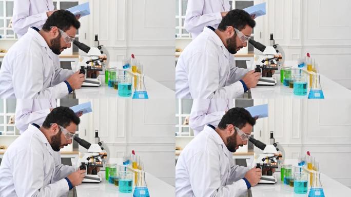 4k特写男科学家在实验室使用显微镜
