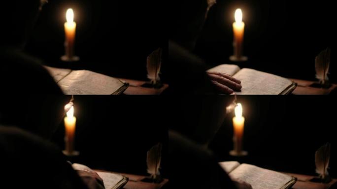 烛光下，老和尚在黑暗的修道院牢房里读旧书的视频。
