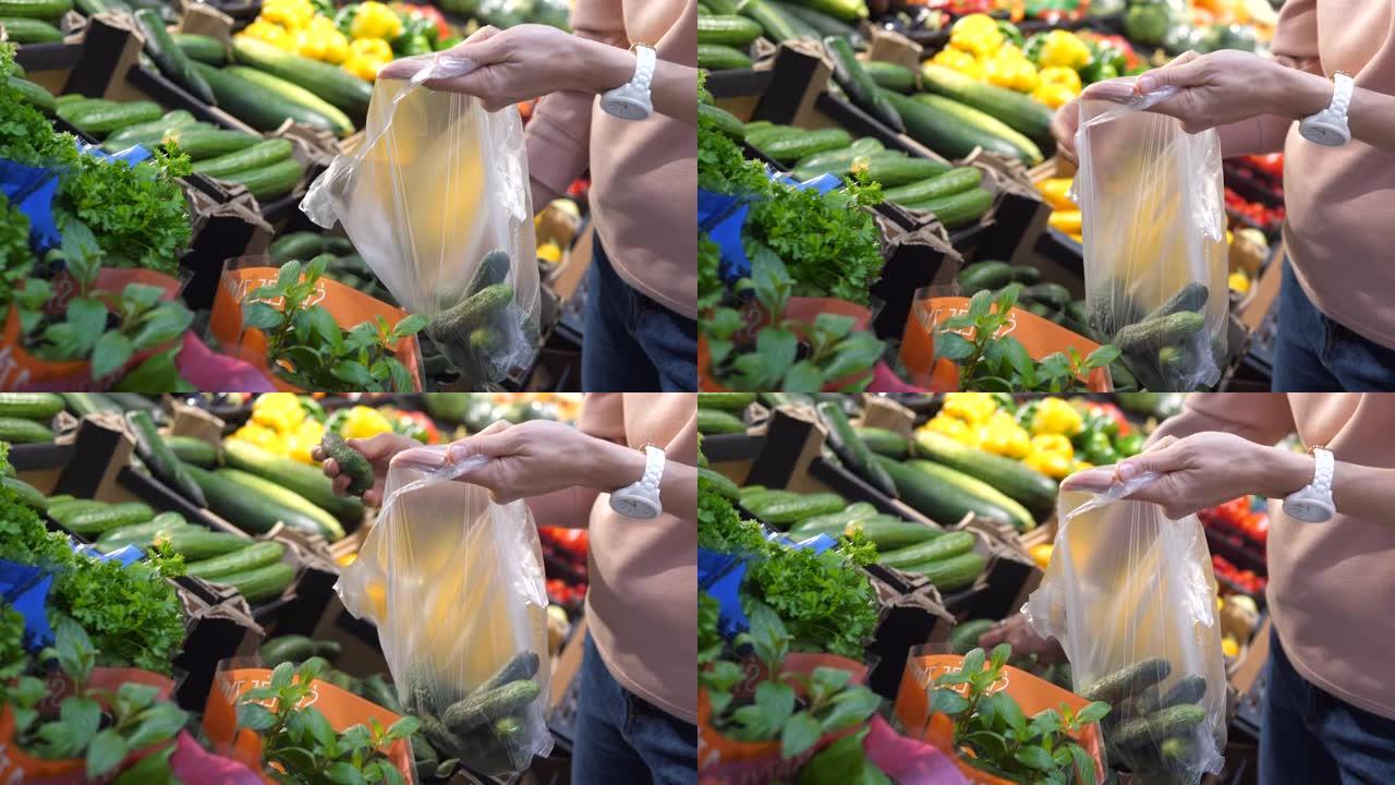 将干燥的黄瓜包装到塑料袋上的手关闭。在农贸市场购买最新鲜的农产品。在商店里买蔬菜和水果，为全家在家准