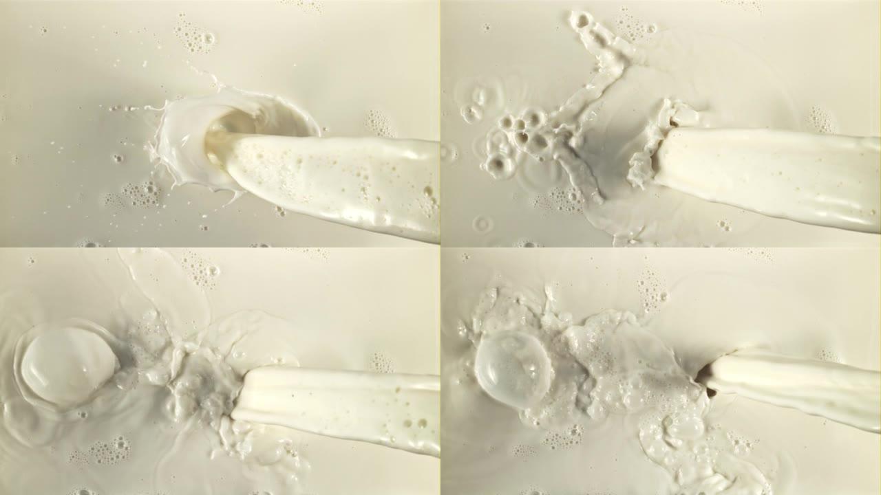 一股牛奶流淌着飞溅和气泡。以1000 fps的高速相机拍摄。
