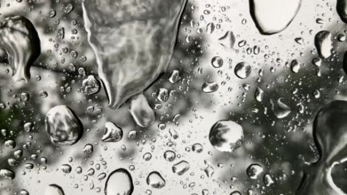 玻璃上的雨滴是玻璃上的一滴水。视力模糊