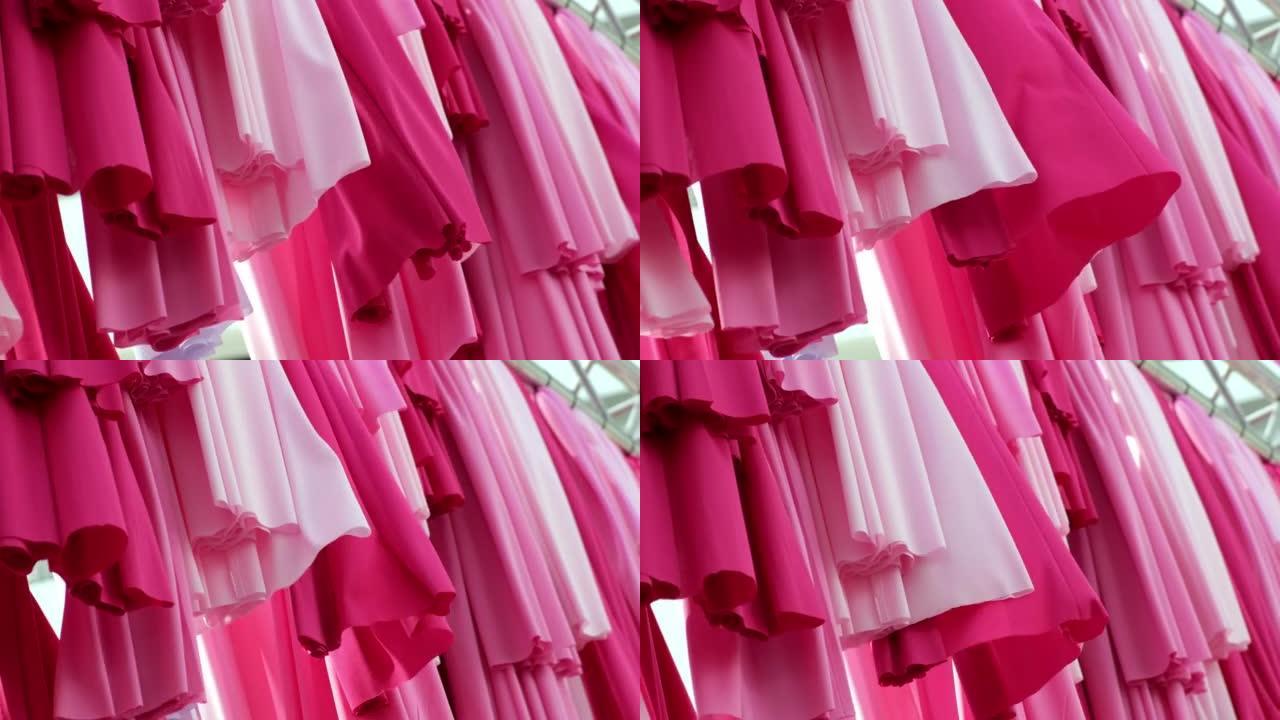 选择聚焦粉色织物衣服悬挂