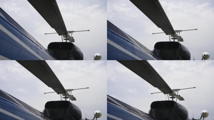 民用旅游直升机的螺旋桨在灰色天空的背景上特写