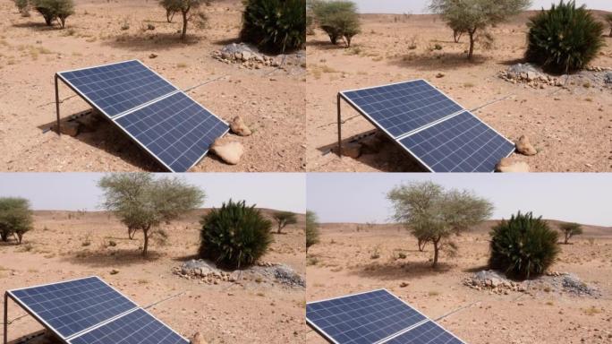 摩洛哥Erg Chigaga撒哈拉沙漠中的太阳能电池板。太阳能从沙漠中的动物和树木的井里取水。