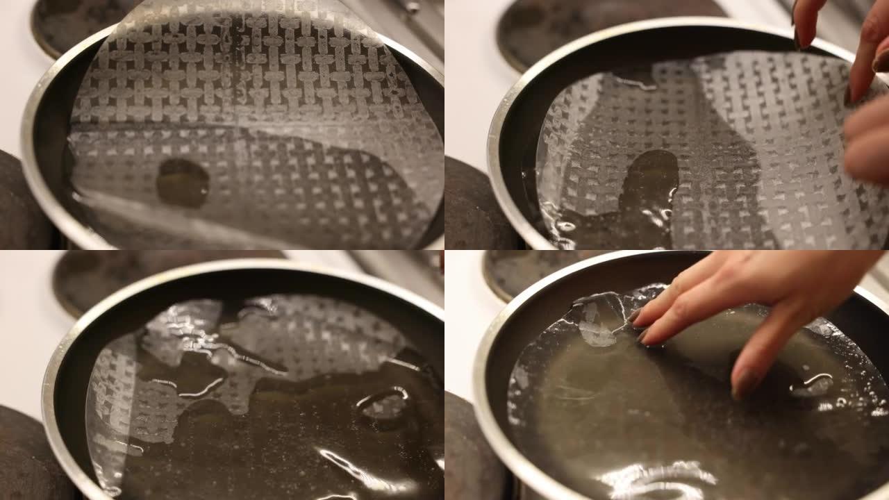 一个女人在锅里用水浸泡宣纸的特写镜头