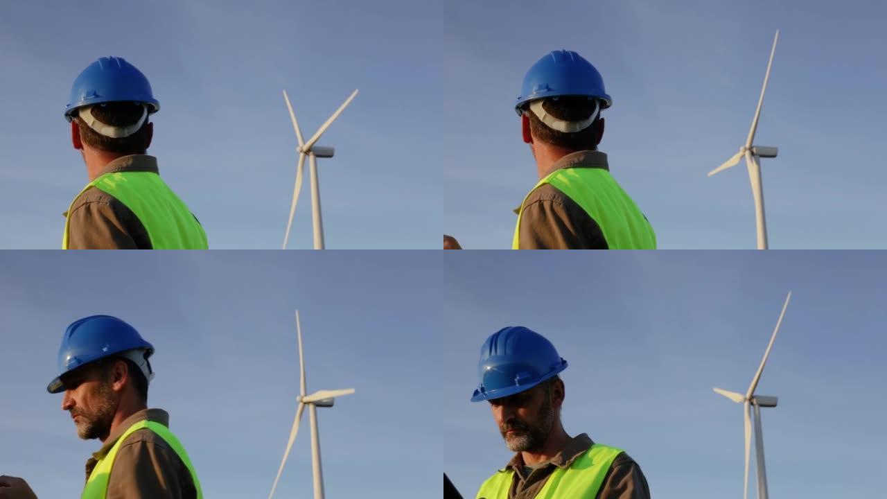 男性可再生能源工程师，从后面检查风塔。他转向摄像机