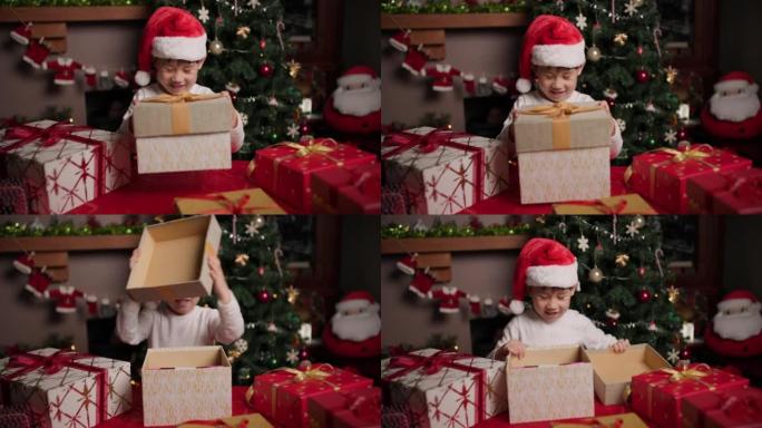 戴着圣诞老人帽子的年轻女孩正在打开她的圣诞礼物盒