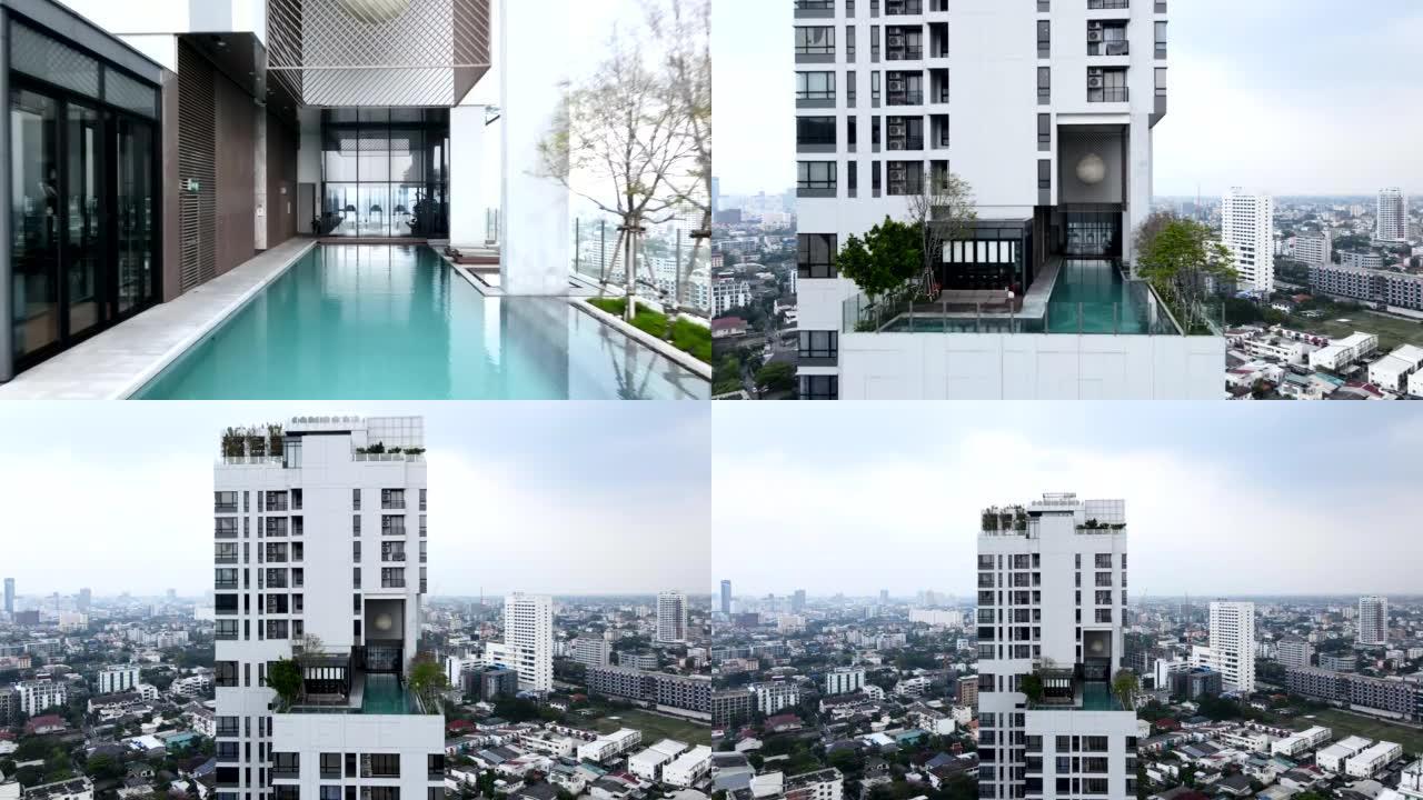飞向泰国曼谷酒店屋顶的无边泳池。空中回撤镜头