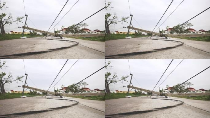 热带飓风过后倒下的电力线杆和电缆。自然灾害的后果