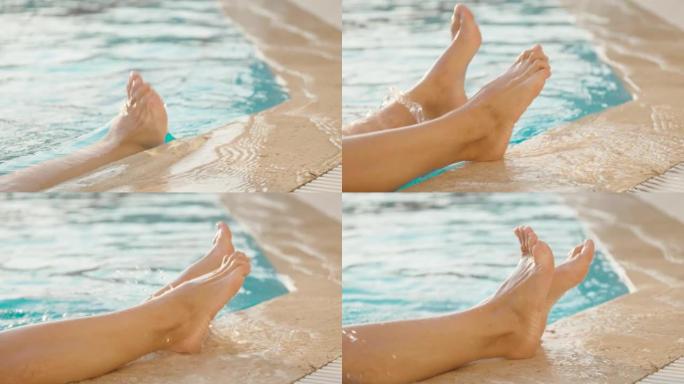 女孩把她的腿从水里抬到游泳池的边缘特写，阳光明媚的日子，她扭动手指。