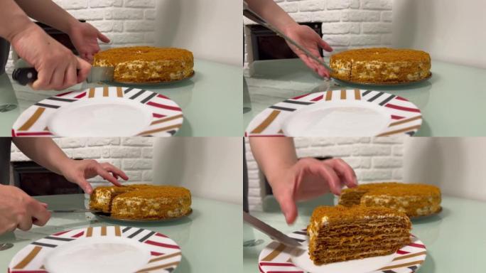 女人的手用刀切开一个自制的蛋糕，然后将一块放在盘子上。