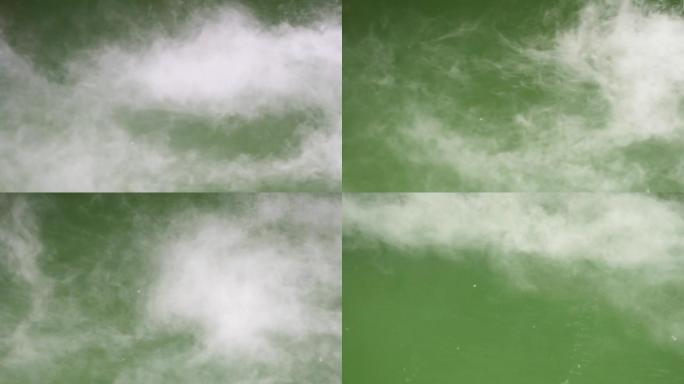 白色的薄雾在绿色的水面上移动