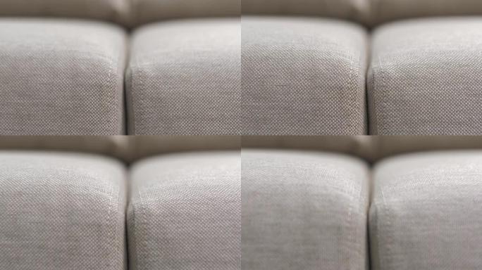米色纺织品软垫沙发和扶手椅靠垫，缝合完美。