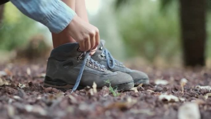 女孩系蓝色登山靴的鞋带