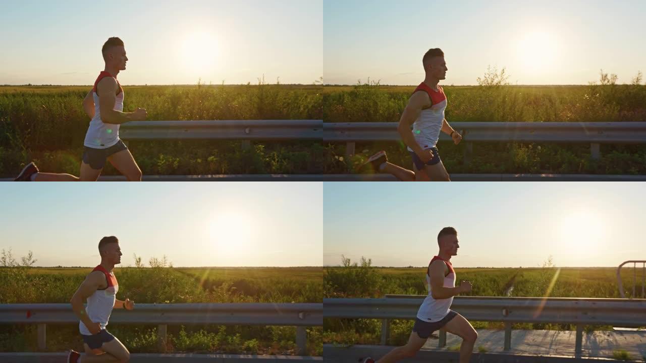 强壮的男人穿着运动服，日落时在马路上快速奔跑。