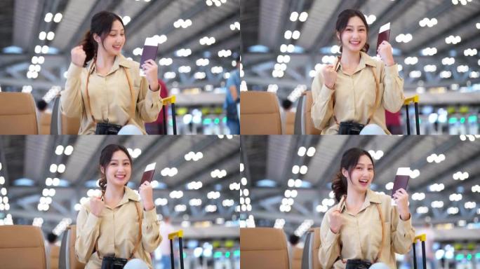 度假假期在机场等待出发的亚洲妇女。肖像微笑的亚洲年轻女子看着镜头。面部表情快乐