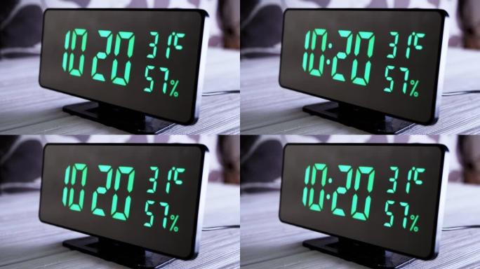 数字时钟在绿色显示上午10:20上显示时间、温度、空气湿度