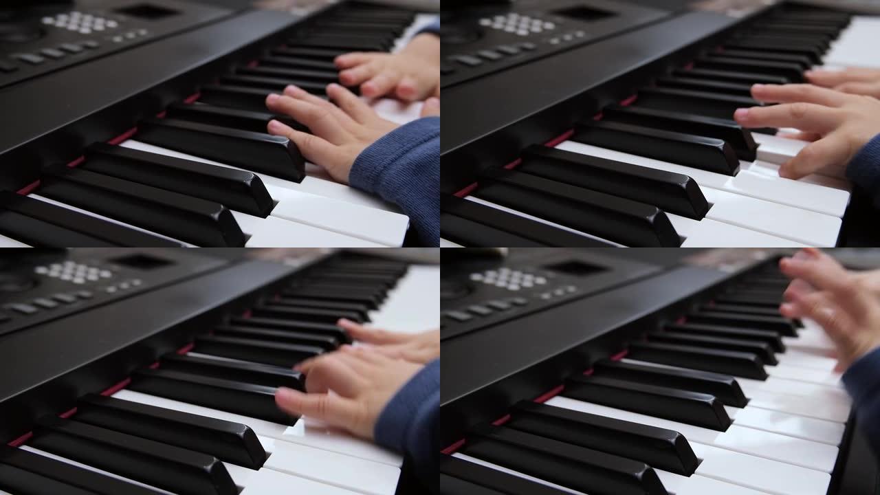 儿童的手指在钢琴合成器的琴键上弹奏。选择性聚焦钢琴按键