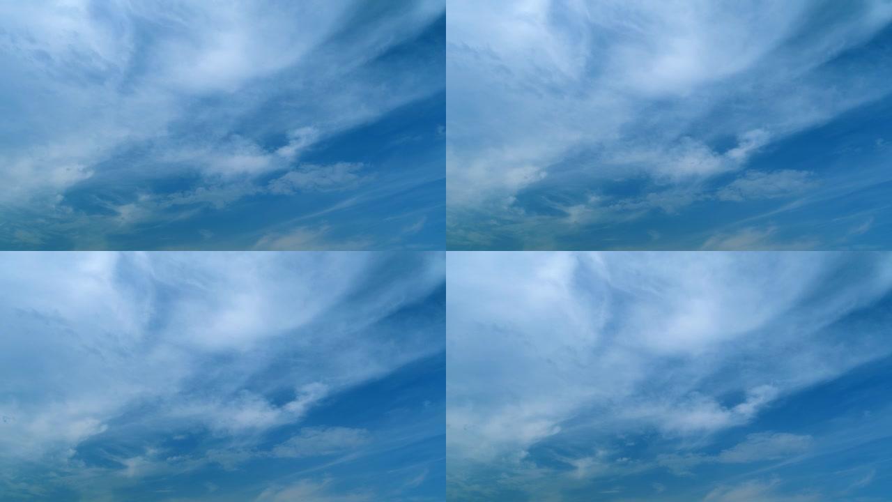 云在蓝天中移动。白天的热带天空，只有白色和蓝色。不同高度的半透明层。延时。