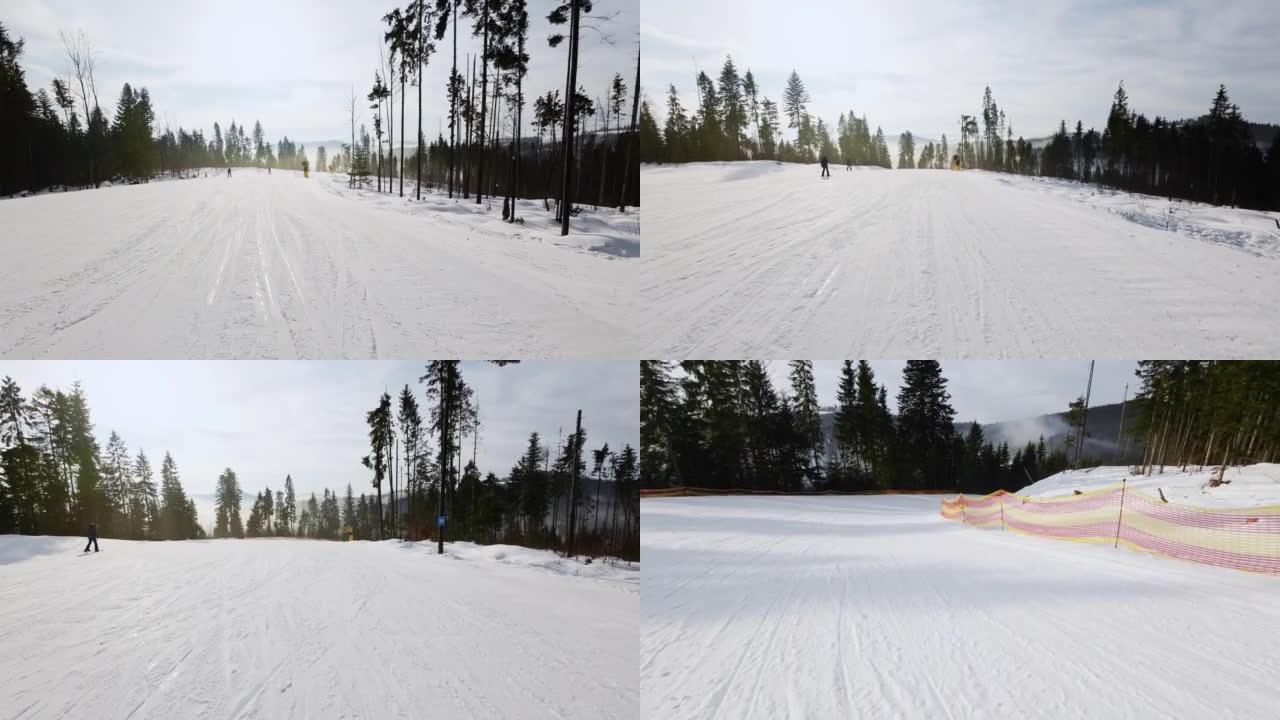 在阳光明媚的日子里，平缓的第一人称滑雪道。