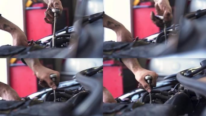 汽车修理工修理汽车发动机。更换喷油器。