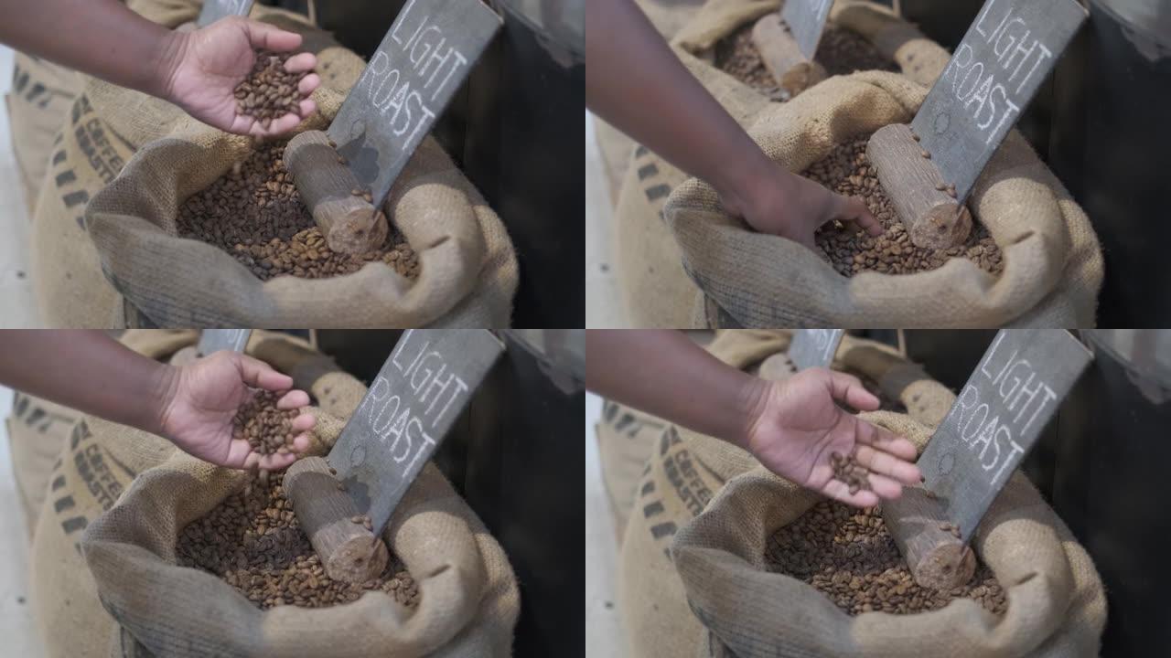 咖啡师用手手动检查烘焙咖啡豆的质量