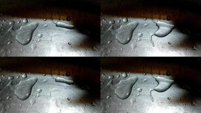水滴的特写镜头缓慢地从金属表面流下。