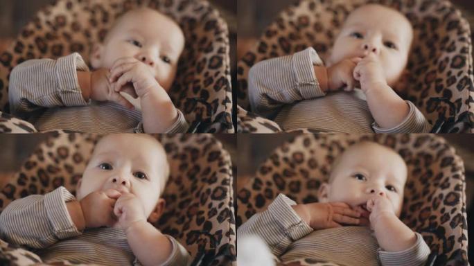 婴儿吮吸手指的肖像。