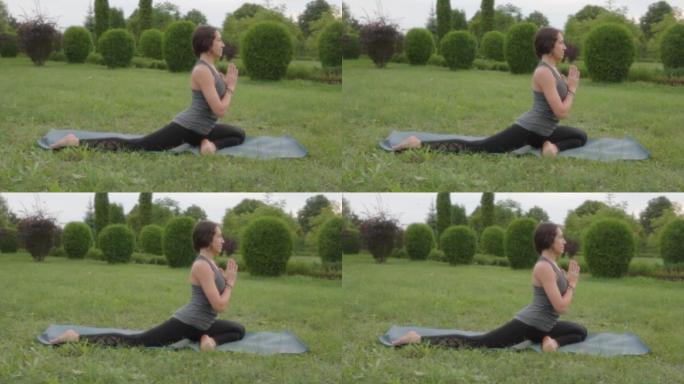 瑜伽教练练习鸽子姿势，合十手势，合十手印。