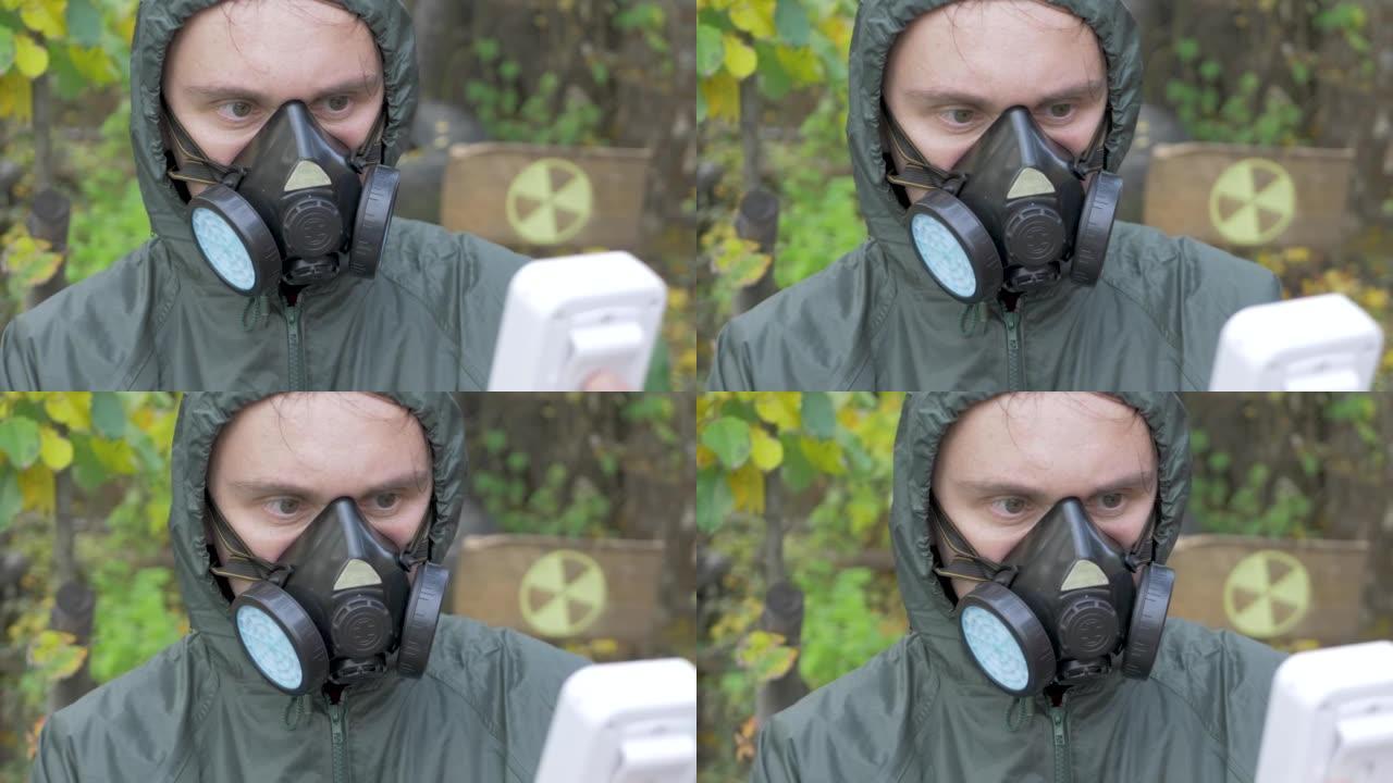 穿着防护服和口罩呼吸器的人使用辐射盖革计数器