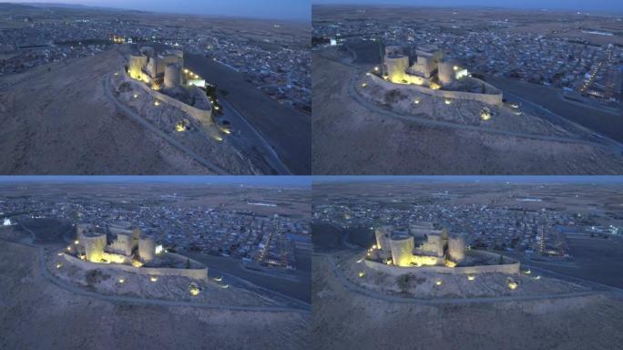 高角度视图山上的一座老堡垒和一个城镇在背景中打开灯在高清