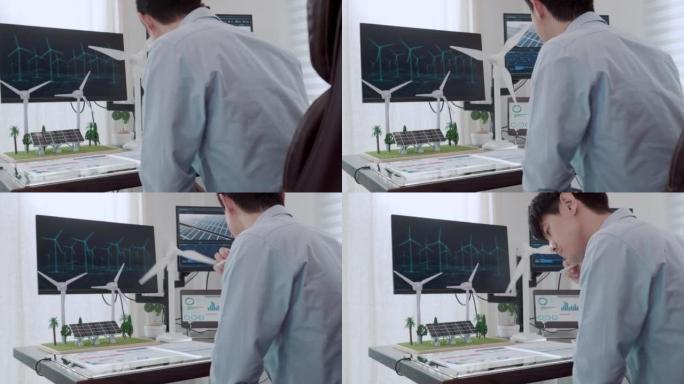 一名男性工程师与计算机全息增强现实3D屏幕一起工作的视频，内容涉及工作室中用于替代能源的风车和太阳能