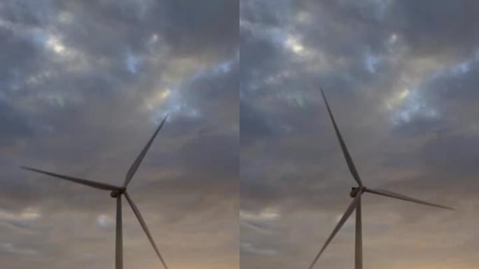 风力风车对抗日落的垂直视频