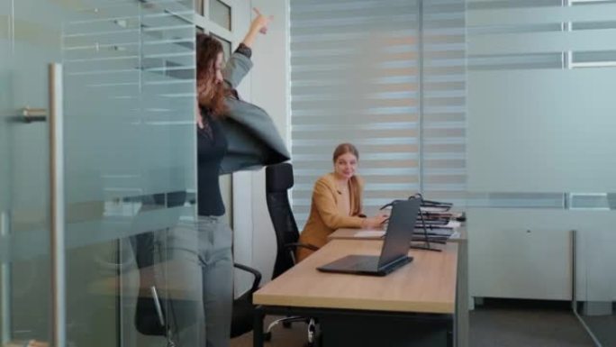 商界女性庆祝成功在工作场所跳舞。