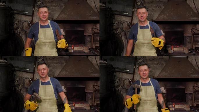一个铁匠的肖像，用锤子和大钳子在一个旧的锻炉中。