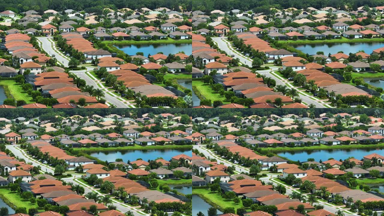 从佛罗里达州南部封闭的生活俱乐部的保留池塘附近密集建造的住宅的上方观看。美国梦homes作为美国郊区