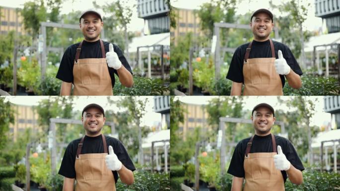 微笑的园丁在树丛里愉快地照顾他花园里的植物。花店花园商店老板业务。男人在后院种树作为一种爱好。小企业