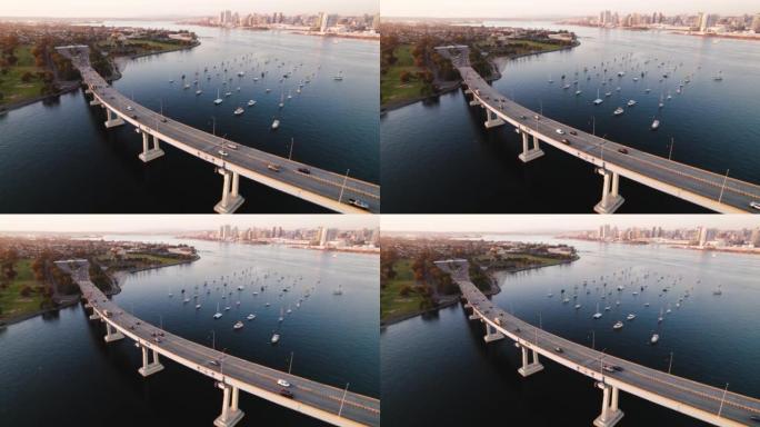加州圣地亚哥的科罗纳多大桥在黄金时段，汽车在圣地亚哥湾过桥和船只。美利坚合众国著名城市天际线