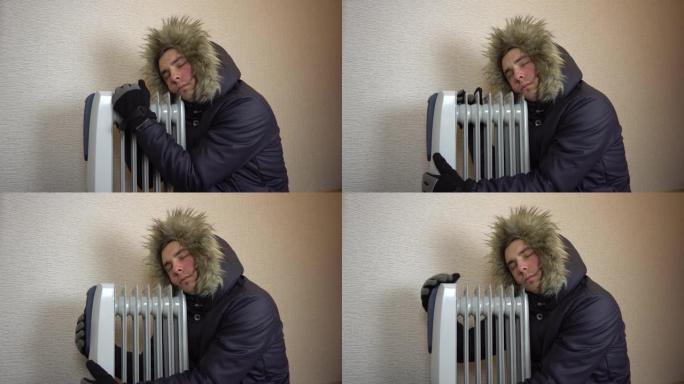 一个穿着皮毛夹克的年轻人拥抱着加热器散热器。一名男子被油冷却器加热。一个人会冻结，因为不可能增加更高